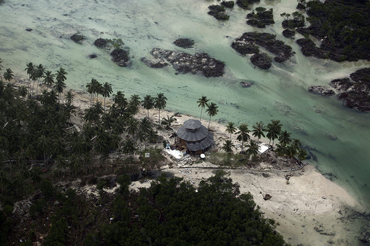 Indonesia Disaster : Photo of a damaged building in a village flattened by Tsunami 