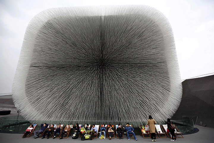 24 Hours In Pictures: Visitors rest in front of the UK Pavilion at the Shanghai World Expo site