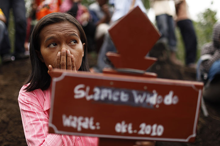 Indonesia update: Julianti sits next to her brother's grave, a victim of the eruption