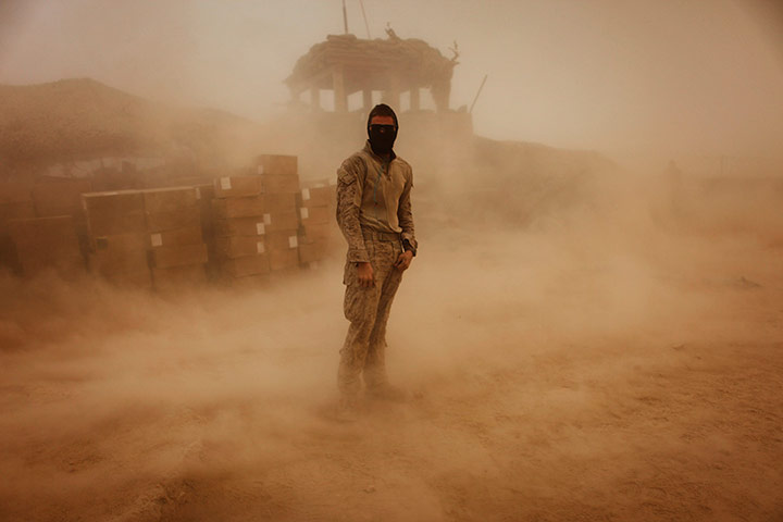 24 hours in pics: Private stands during a sandstorm in southern Afghanistan Helmand province