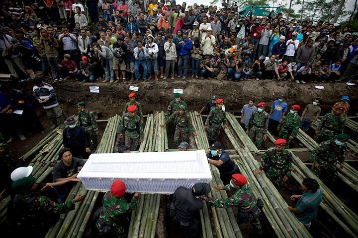 24 hours in pics: Soldiers carry the coffin a victim of the Mount Merapi eruption