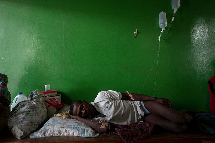 24 hours in pics: A man suffering from cholera sleeps on a bench, Haiti