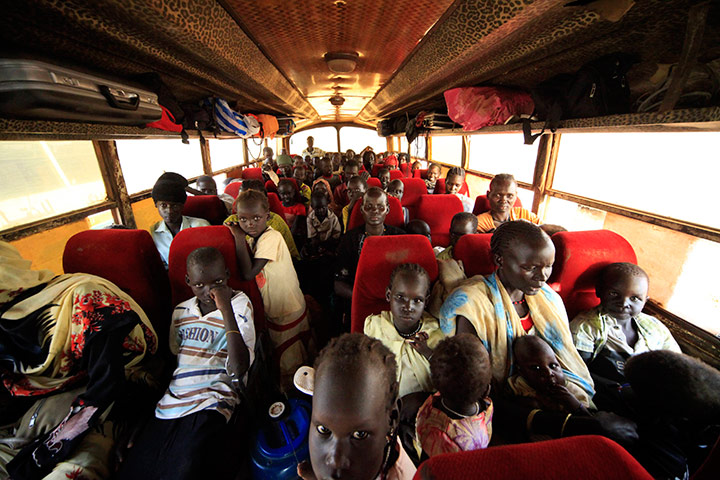 24 hours in pics: A group of internally displaced people (IDP) sit inside a bus, Sudan
