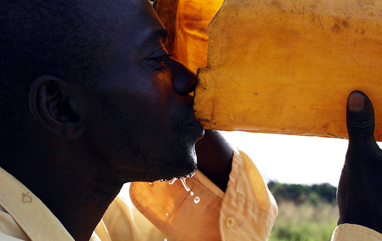 Katine Eyewitness: A man drinks at a borehole in Katine