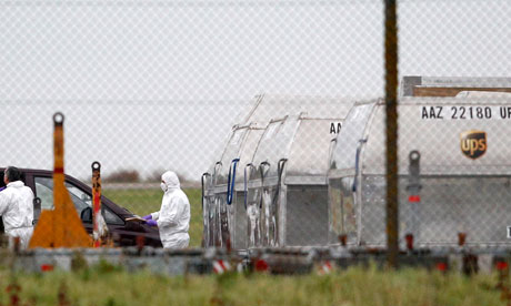 Forensic officer removes package from UPS container