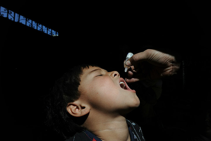 24 hours in pictures: An Afghan health worker administers poli