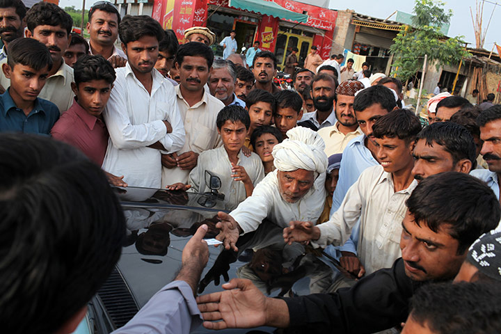 Pakistan floods- Punjab: A constituent reaches out to touch the hand of Jamshed Dasti