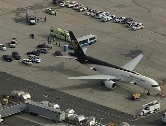 Cargo Terror: A UPS plane sits surrounded by law enforcement officials in Newark