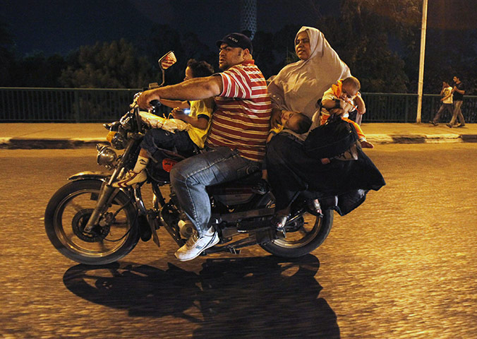 24 hours in pictures: Cairo, Egypt: A family of five ride on a motorcycle 