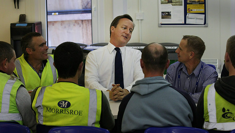 Conservatives day 1: Prime Minister David Cameron talks to workers as he visits a building site 