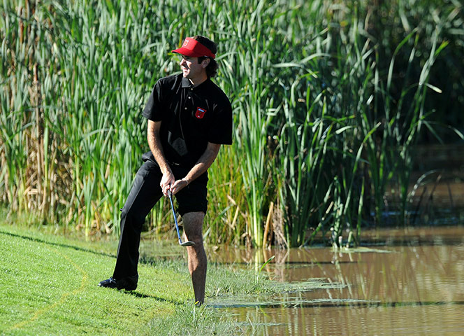 Ryder Cup Day 4: US Ryder Cup player Bubba Watson removes shoes. Ryder Cup 2010