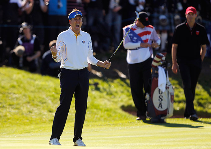 Ryder Cup Day 4: Ian Poulter of England reacts after sinking his putt on the 14th Ryder Cup