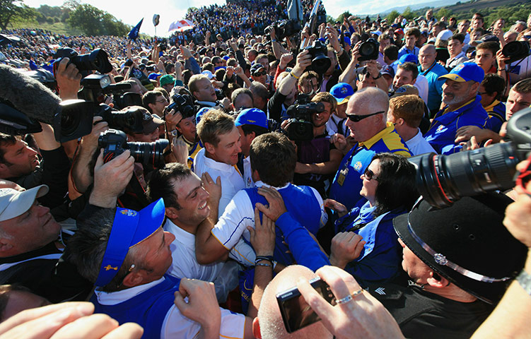 Ryder Cup Day 4: Graeme McDowell of Europe is mobbed by his team mates after his 3&1 win