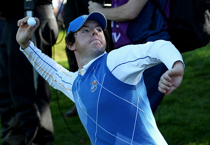 Ryder Cup Day 4: Rory McIlroy of Europe throws his ball to the crowd after halving his match