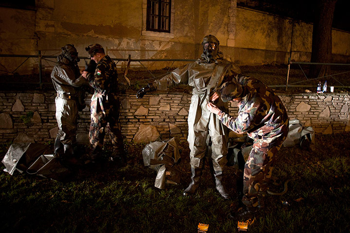 24 hours in pictures: Soldiers get on protective gear, reservoir containing toxic sludge