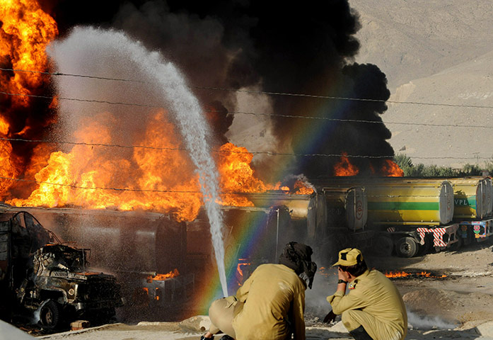 Pakistan tankers attack: Pakistani firefighters try to extinguish burning NATO supplies oil tankers