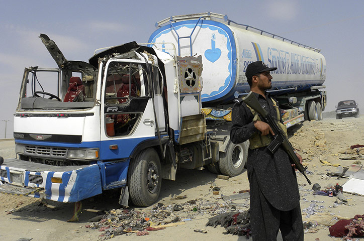 Pakistan tankers attack: 30 September: A Pakistani border security guard stands near a tanker