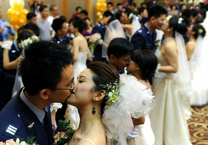 24hours: Newly wed couples kiss during a Mass wedding