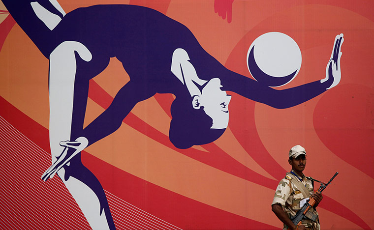 Commonwealth Games Day 4: An Indian security officer stands guard at the Commonwealth Games