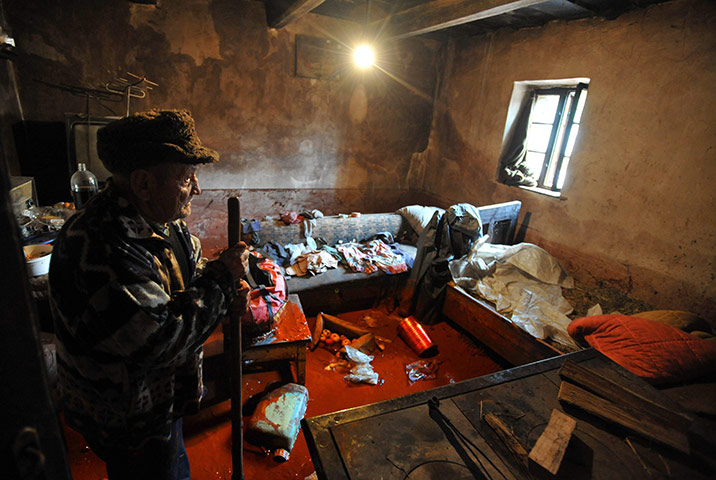 Toxic sludge Hungary: Jozsef Horvath stands in a room of his house covered with red mud, Devecser
