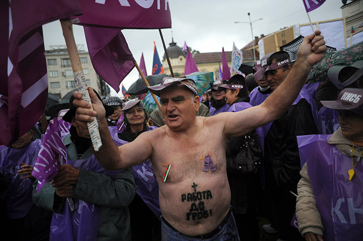 24 hours in pictures: A protestor shouts slogans in front of the Parliament building Sofia