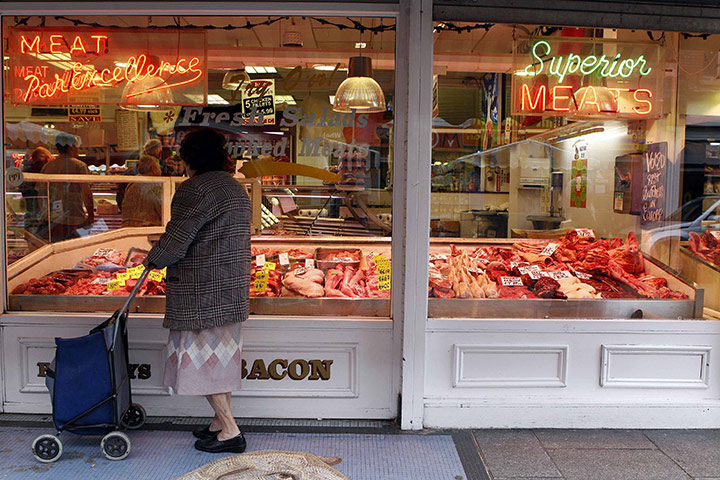 Week in Business: A woman looks into a butchers shop, on the north side of Dublin.