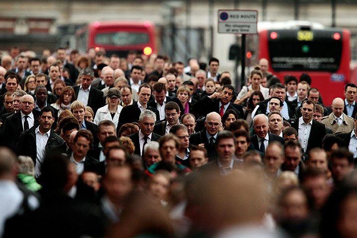 Week in Business: Commuters walk across London Bridge during the underground strike