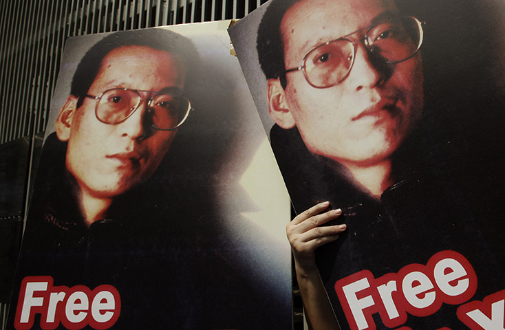 Liu Xiaobo Nobel Peace: Pro-democracy activists hold pictures of Chinese dissident Liu Xiaobo