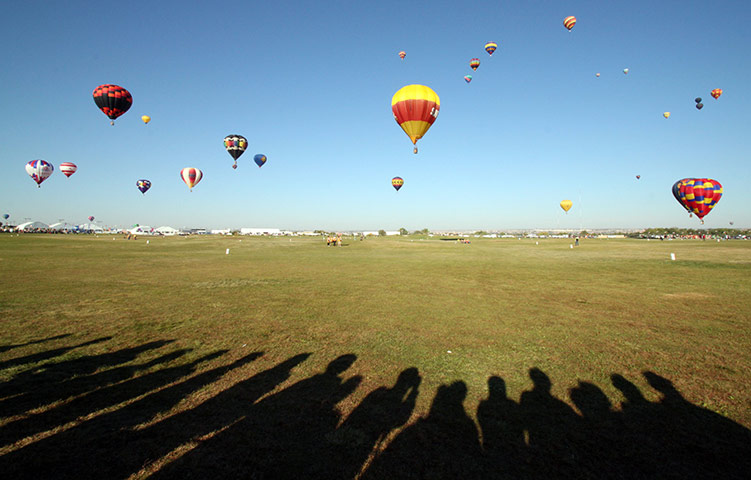 24hours: Spectators line the edge of the launch field as hot air balloons rise 