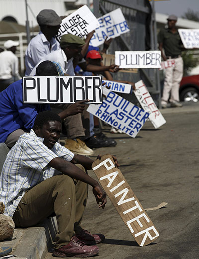 24hours: Men hold placards offering temporal employment services in Glenvista