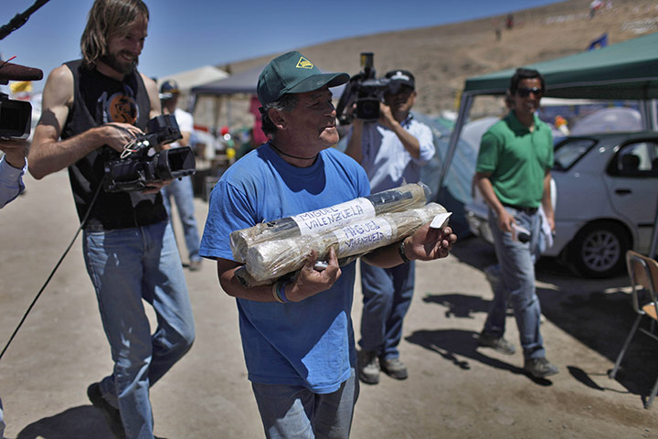 Trapped Chile miners: 7 October: Miguel Valenzuela carries packages sent up to him by his friend
