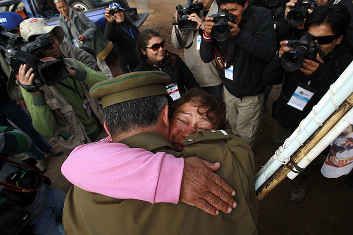 Chile Miners Rescue: A relative is hugged by a policeman near to the mine