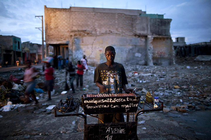 24 hours in pictures: A hot dog vendor works in downtown Port-au-Prince, Haiti