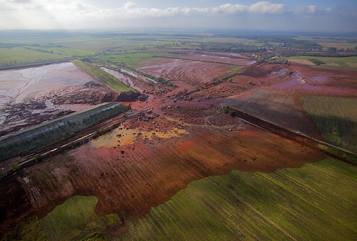 24 hours in pictures: view of the broken dyke of a reservoir containing toxic red sludge