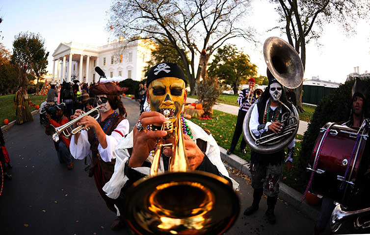 Obama halloween: A band is performing for Halloween as people gather at the White House