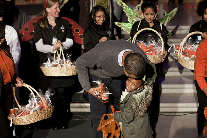 Obama halloween: U.S. President Barack Obama hugs a trick or treater at the White House 
