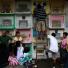 All saints day: A Filipino man places candles on the tomb of a relative at cemetery