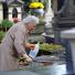 All saints day: A woman cleans a relative's grave on the All Saints day