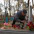 All saints day: Man lights candle on a grave at a cemetery in the village of Ivenets