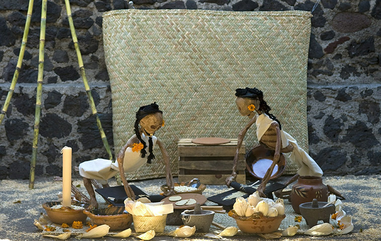 All saints day: Two paper skeletons as representation of people cooking Mexican tortilla