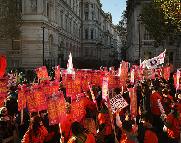 Students protest: Students hold placards as they march past Downing Street in London