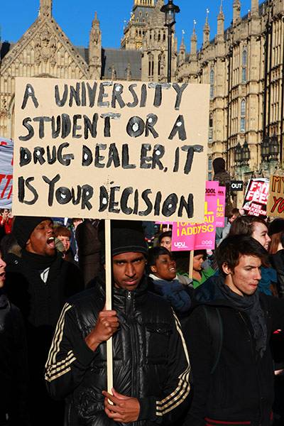 Students and slogans: Student or drug dealer placard outside Parliament
