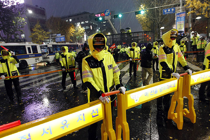 G20 Seoul: Heavy rain falls as South Korean policemen during an anti-G20 protest