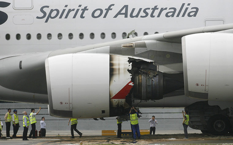 Week in Business: Technicians look at the damaged engine of Qantas Airways A-380 plane QF32