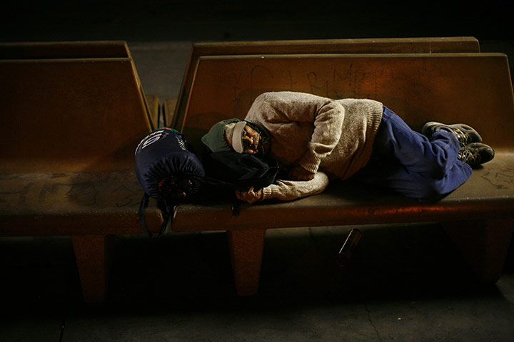 24 hours in pictures: A man sleeps on a bus bench in Calexico, California