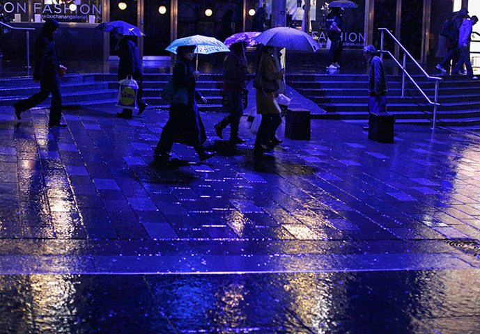 Week in Business: People walk through a rain shower in Buchanan Street in Glasgow