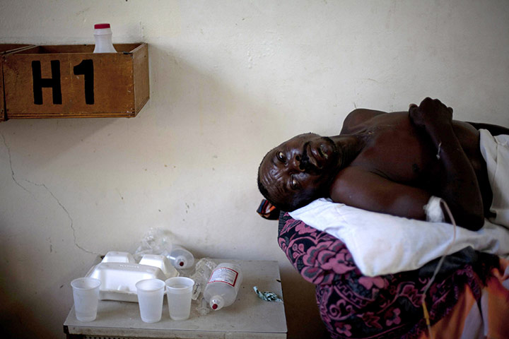 Cholera in Haiti: A man lies on a bed at a hospital in Port-au-Prince