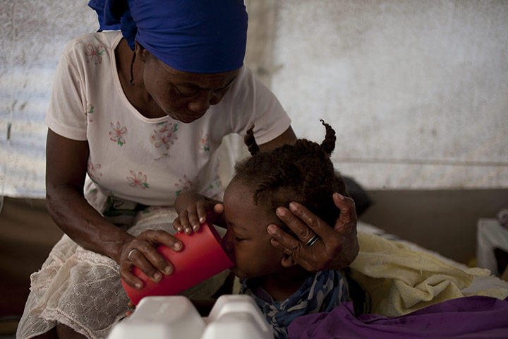 Cholera in Haiti: A woman with her daughter who is suffering from cholera, Port au Prince