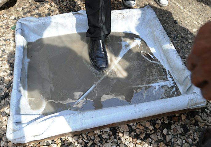 Cholera in Haiti: A man steps into a disinfectant wash prior to entering a hospital