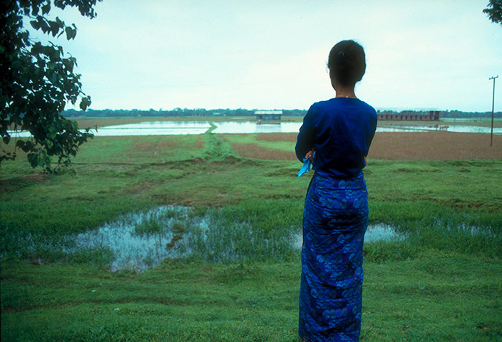 Aung San Suu Kyi release: 1989: Aung San Suu Kyi standing near river bank, north of Rangoon